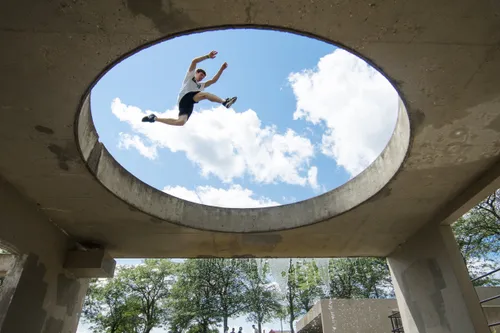 Professional parkour performer demonstrating wall run technique